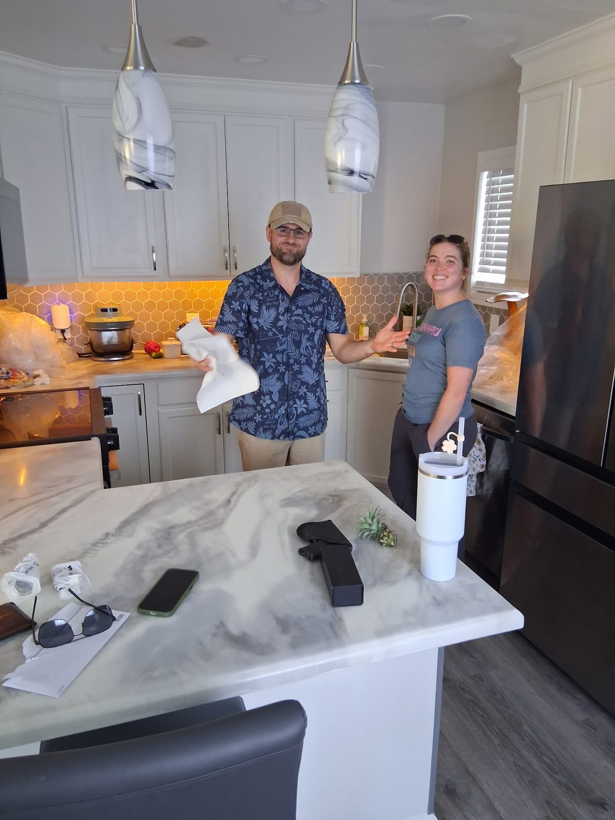 Gray-swirled island in the kitchen with its occupants.