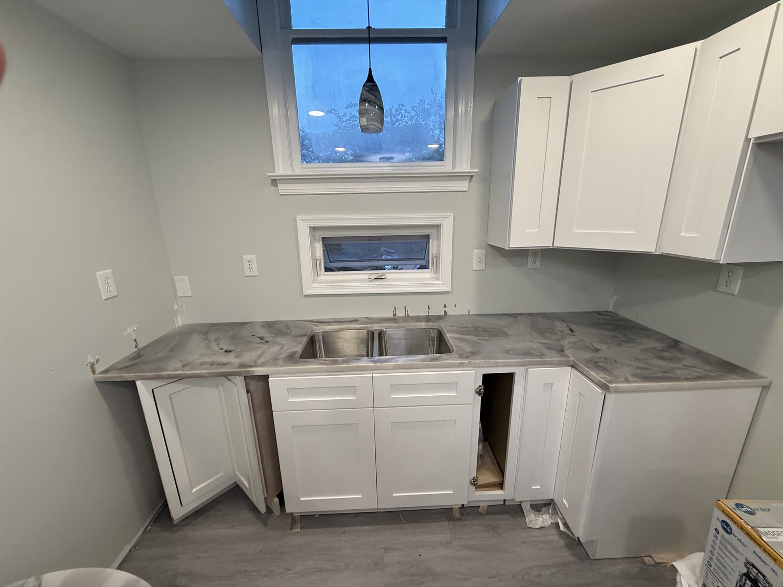 Installed sink countertop with surrounding kitchen renovation still underway.